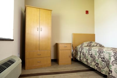 A private resident room with basic furniture