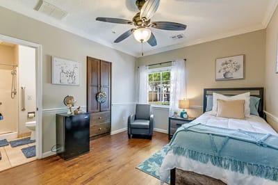 Bright interior room with a bed and chair