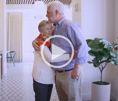 Residents embracing in a cozy common area