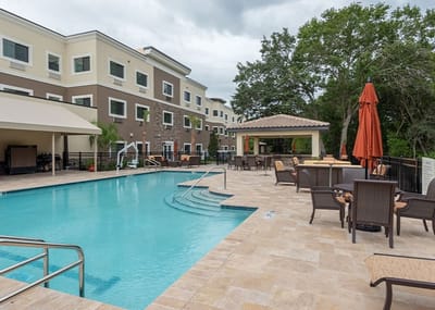 Outdoor pool area with seating and umbrellas
