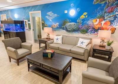Bright interior common area with seating and colorful mural