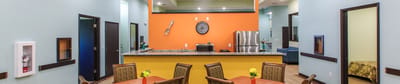 Bright common area with kitchen and dining setup