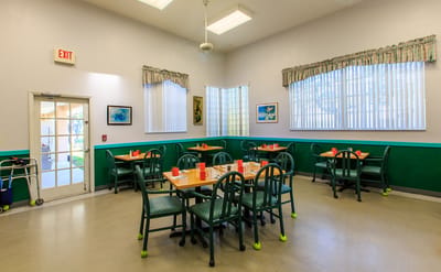 Bright dining room with tables set for meals