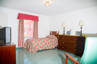 Cozy resident room with floral bedding and furniture