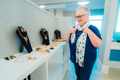 Resident enjoying a jewelry display in a common area
