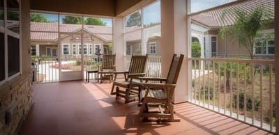 Porch area with rocking chairs overlooking gardens