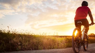 A person biking at sunset in an outdoor space