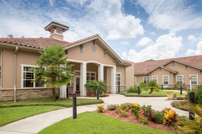 Exterior view of Mission Oaks Assisted Living building with gardens