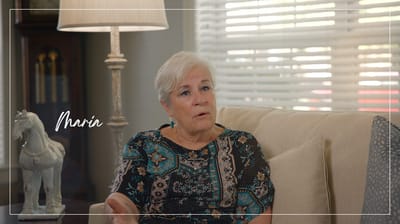 Resident Maria talking in a cozy interior space