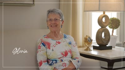A smiling resident sitting in a cozy interior