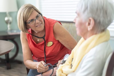 Staff member assisting a resident during a check-up