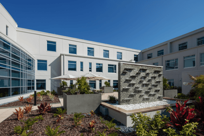 Outdoor courtyard with a water feature and landscaping