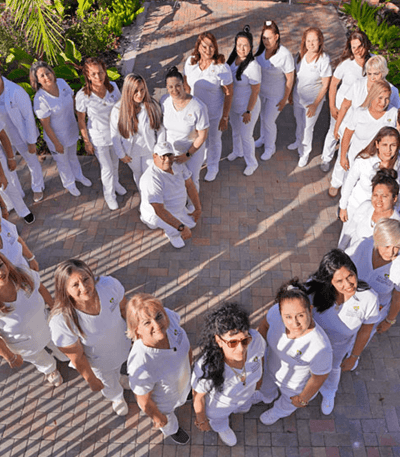 Staff members posed outdoors in matching uniforms