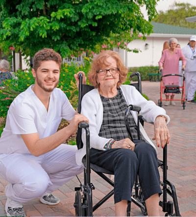 Staff member assisting a resident outdoors