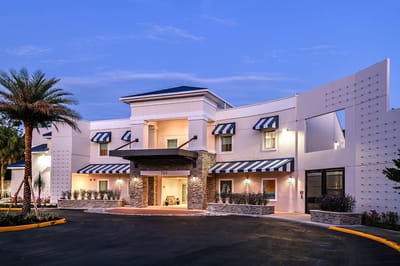 Providence Living at Maitland, assisted living in Orlando, FL — Senior living facility with palm trees and landscaped entrance