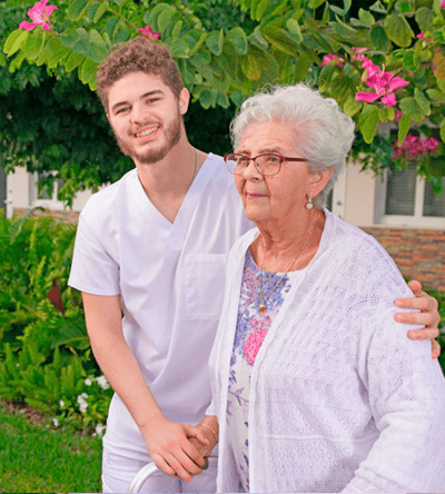 Staff member with resident in a garden area