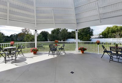 Outdoor gazebo area with seating and flowers