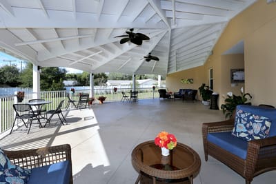 Covered outdoor seating area with floral decor