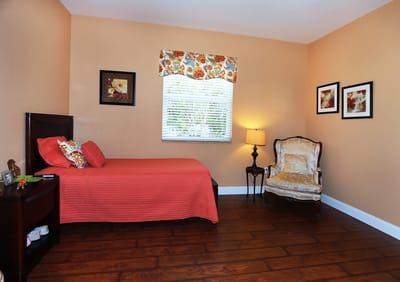 Cozy private resident room with bed and chair