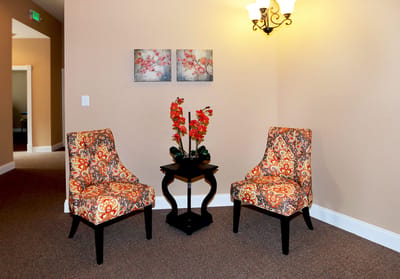 Cozy seating area with decorative chairs and flowers