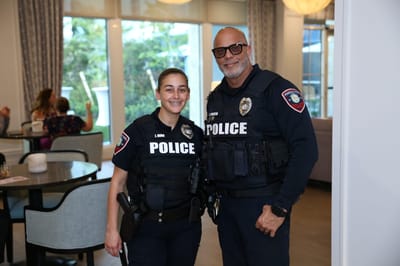 Two police officers smiling in a common area
