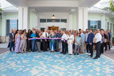 Ribbon-cutting ceremony with a large group of attendees