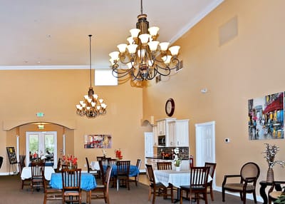 Bright dining area with elegant chandeliers and tables