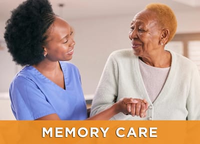 A caregiver assisting a resident in a bright, warm setting