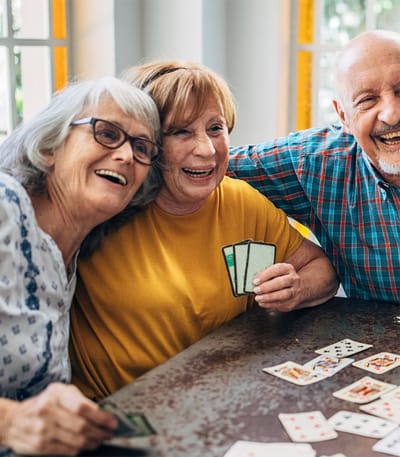 Seacoast at Uptown Oaks, assisted living in Tampa, FL — Seniors enjoying a card game and smiling together