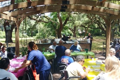 Residents enjoying food at an outdoor gathering