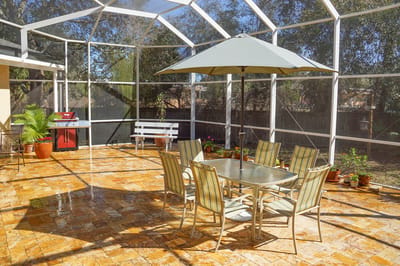 Outdoor patio with seating and umbrella in a sunny environment