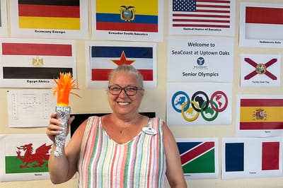 Staff member celebrating at a senior event with decorations