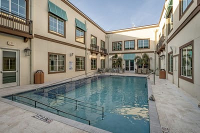 Outdoor pool area surrounded by the building exterior