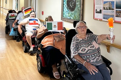 Residents participating in a celebratory activity with flags