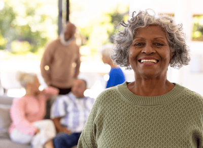 Resident smiling in a common area with others