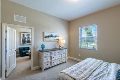Cozy bedroom area with light decor and furniture