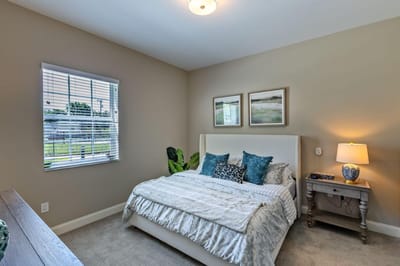 A cozy private resident room with bed and decor