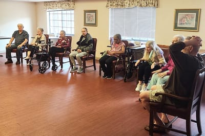 Residents seated in a common area of the facility