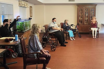 Residents participating in a group activity in the common room