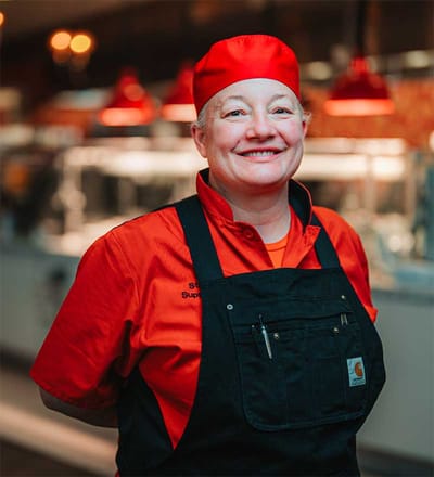 Staff member smiling in a dining area