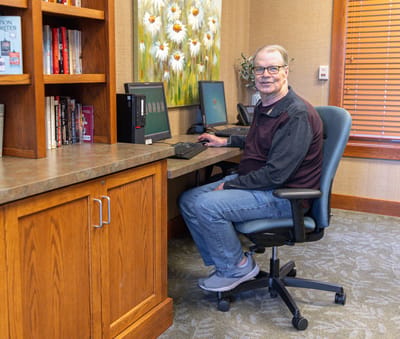 Resident using a computer in a cozy common area