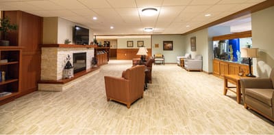 A spacious common area with seating and a fireplace