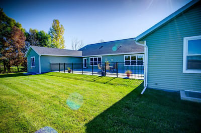 Exterior view of the facility with a fenced patio