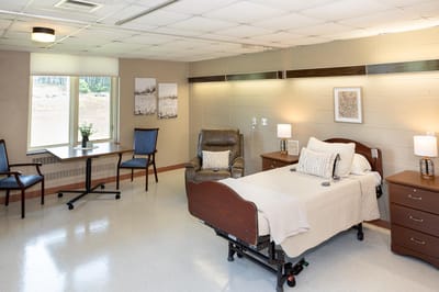 Bright private resident room with bed and sitting area