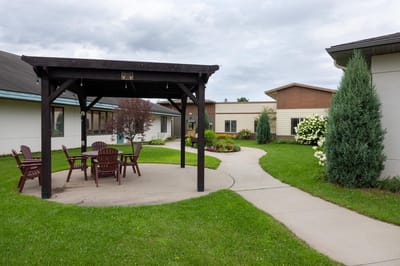 Outdoor patio area with seating and landscaped garden