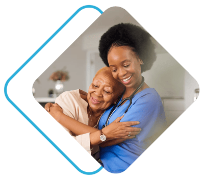 Serenity Spring Senior Living at Scandia Village, nursing home in Sister Bay, WI — Caregiver embracing a senior resident with joy