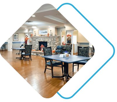 Serenity Spring Senior Living at Scandia Village, nursing home in Sister Bay, WI — Cozy communal area with chairs and a stone fireplace