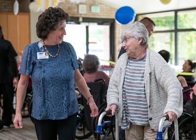 Staff interacting with a resident in an activity area