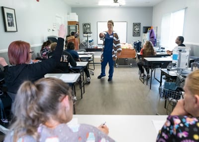 Instructor teaching a class to staff members