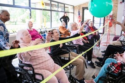 Residents enjoying a balloon volleyball activity